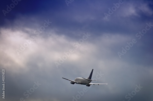 Jet airliner against stormy sky