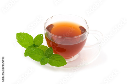 Transparent teacup with tea and peppermint