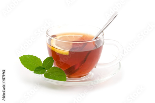 Transparent teacup with tea and lemon
