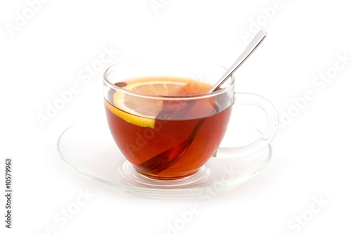 Transparent teacup with tea and lemon