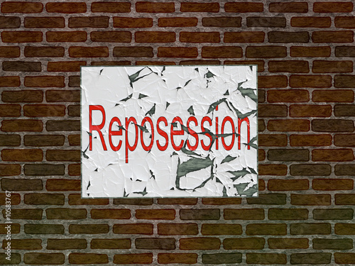 Brick wall of home with faded reposession poster photo