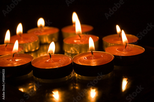lit candles on black background