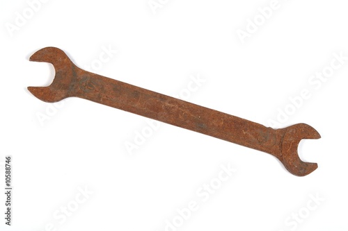 Old rusty spanner isolated on white background.