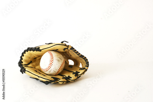 Soft ball and glove on white