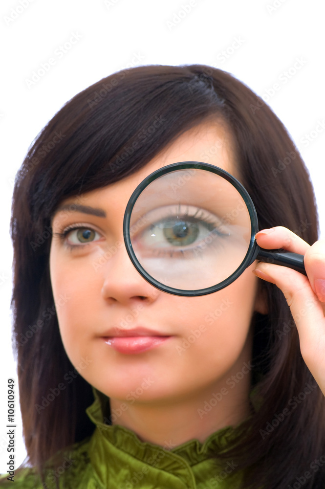Girl's eye magnified through magnified glass on white Girl's eye magnified through magnified glass on white