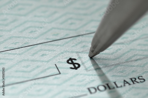 Closeup of pen writing on a blank bank check