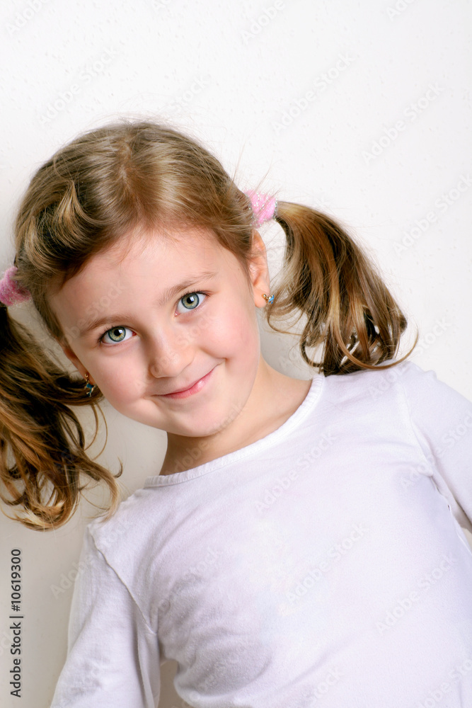 a five year old girl is smiling a five year old girl is smiling