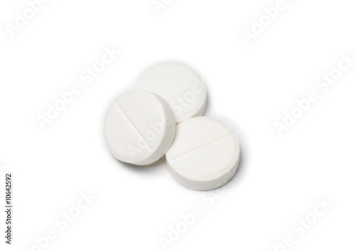 Three white round pills photo