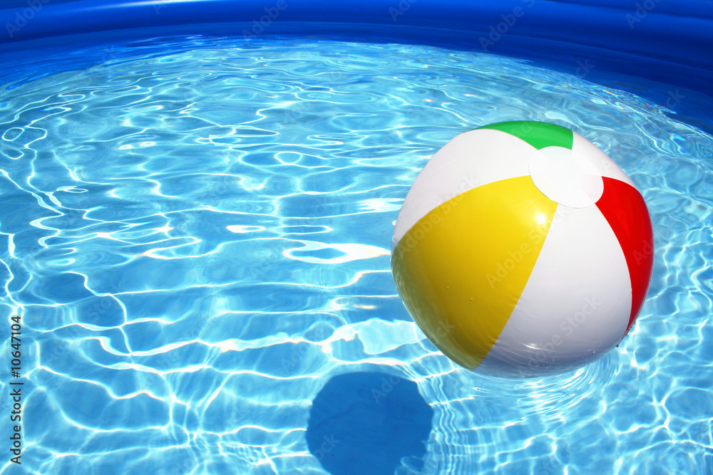 Beach ball floating on pool