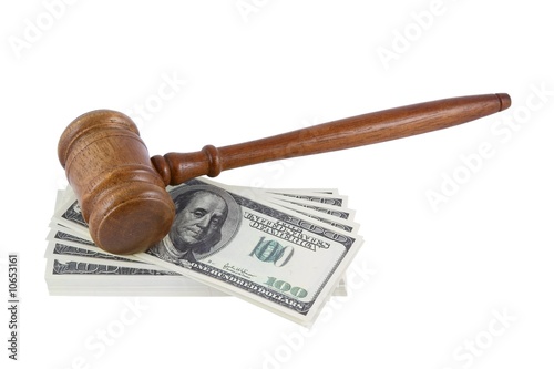 Wood gavel over some bank notes isolated