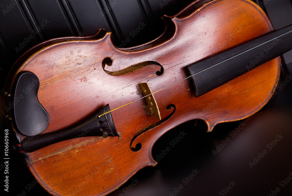 Old distressed violin with one string Old distressed violin with one string