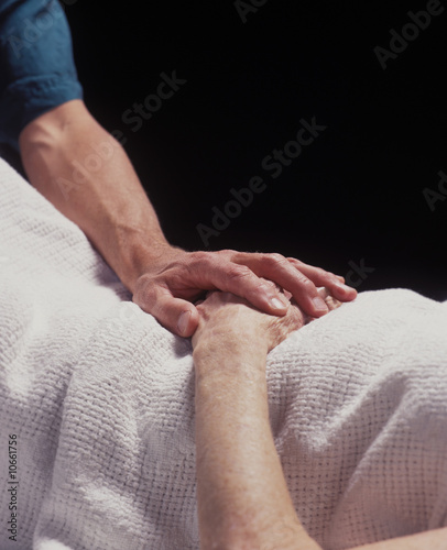 hand of a healer touches the hand of the elderly infirmed