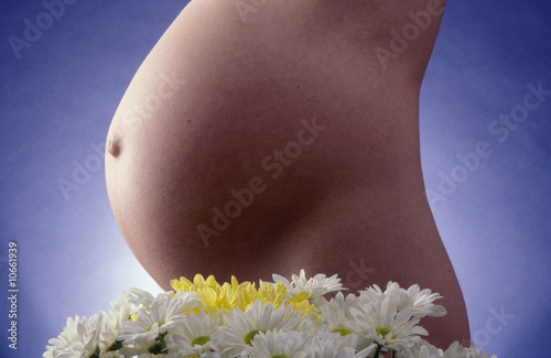 a very pregnant woman in her eighth month photo