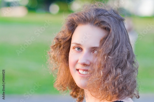 head of young pretty girl with curly hair smiling