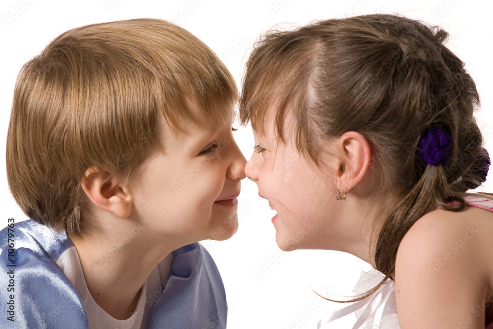 Two smiling little girls sit face to face Two smiling little girls sit face to face