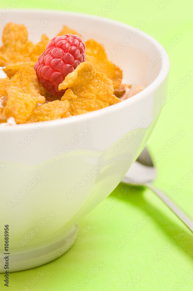 bowl of corn flakes with raspberry bowl of corn flakes with raspberry