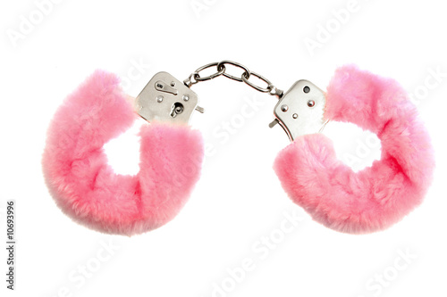 Pink soft handcuffs isolated on white