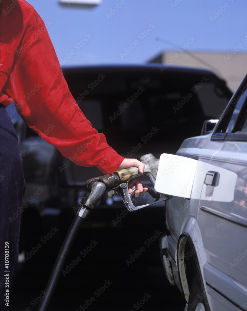 a woman fueling her car