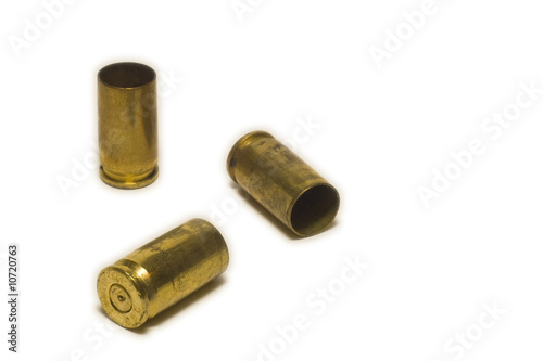 9 mm pistol shell casings on white background photo