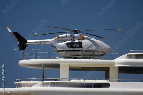 Silver helicopter on yacht heliopad