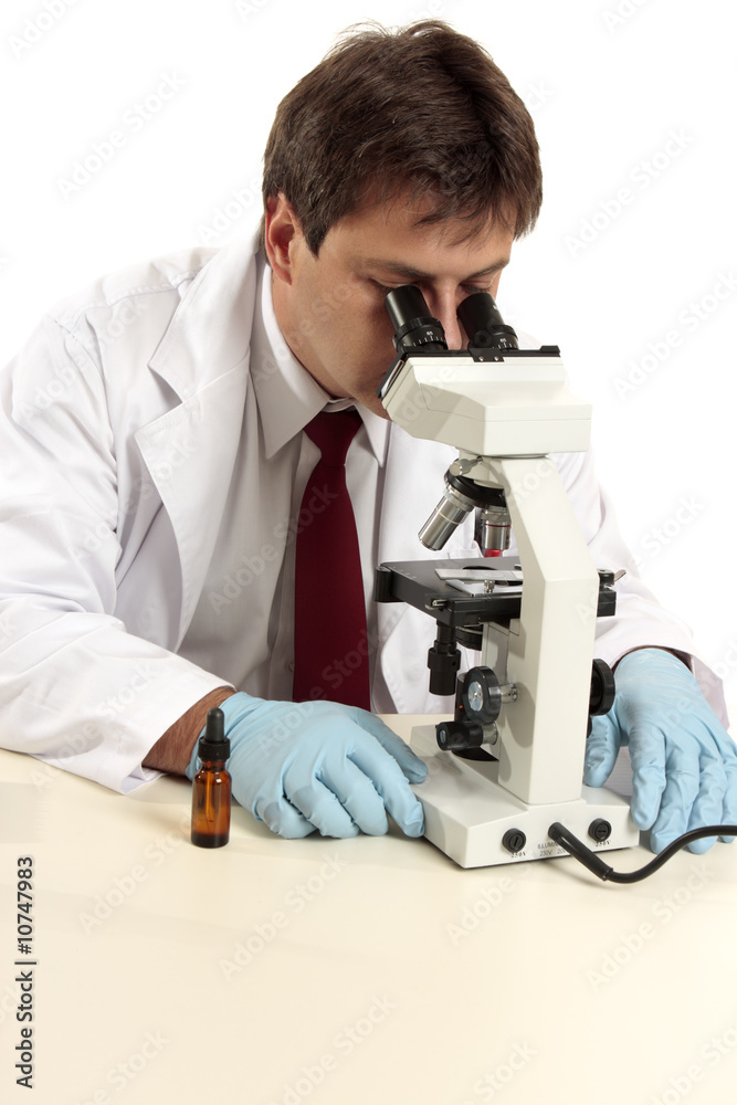 Researcher viewing substance under microscope