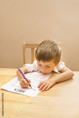 Little boy learning to write.