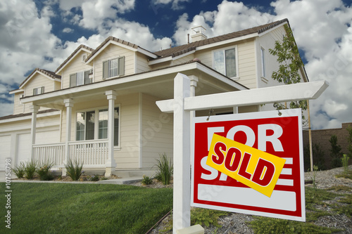 Sold Home For Sale Sign and House