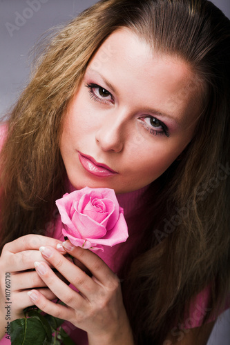 Pretty woman with pink rose © Raisa Kanareva