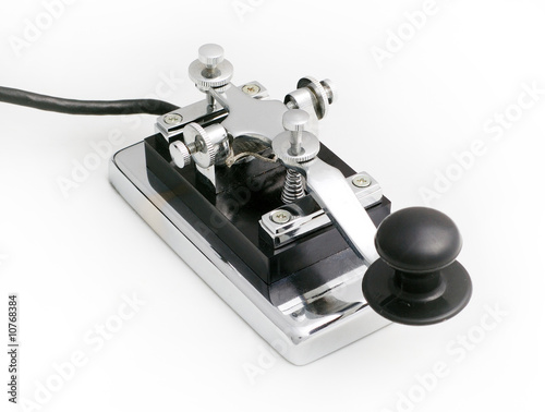 vintage morse telegraph key with white background photo