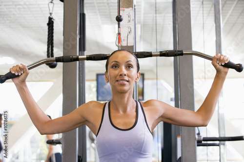 Woman Weight Training At Gym