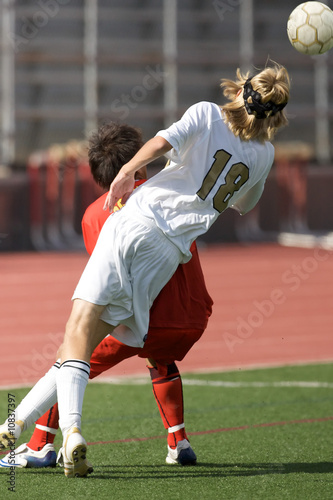 High school soccer players vying for a header