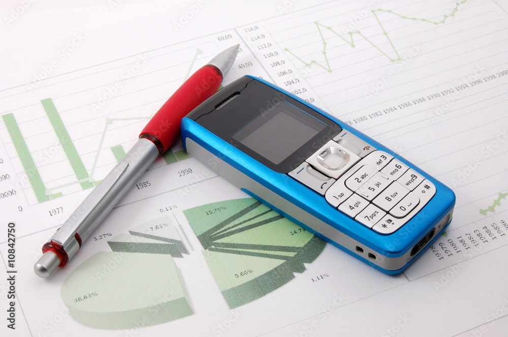 cell phone over business chart cell phone over business chart