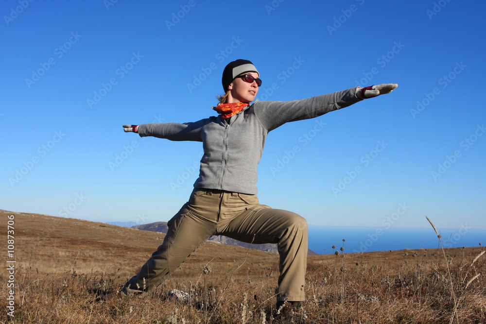 Girl doing meditation on field against the sky.. Girl doing meditation on field against the sky..