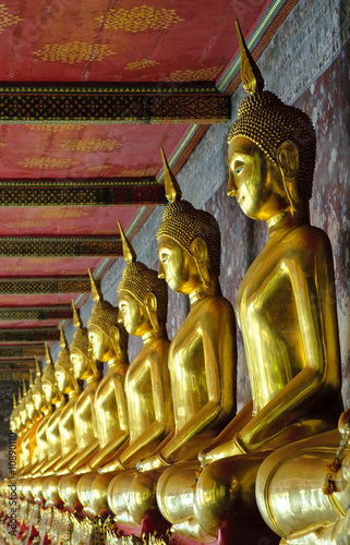 golden buddhas in wat sutat, bangkok photo