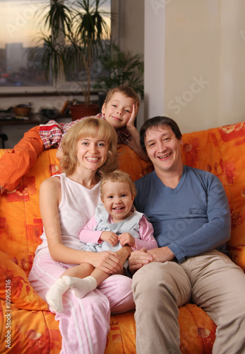 Happy family of the house on a sofa