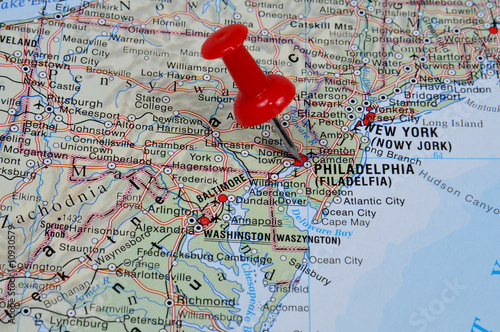 Red pin pointing on Philadelphia on USA map in atlas