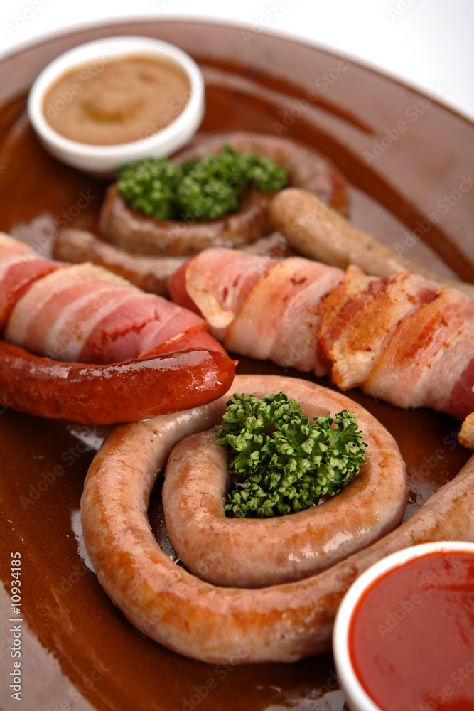 Sausages in assortment with a tomato sauce and mustard. Sausages in assortment with a tomato sauce and mustard.
