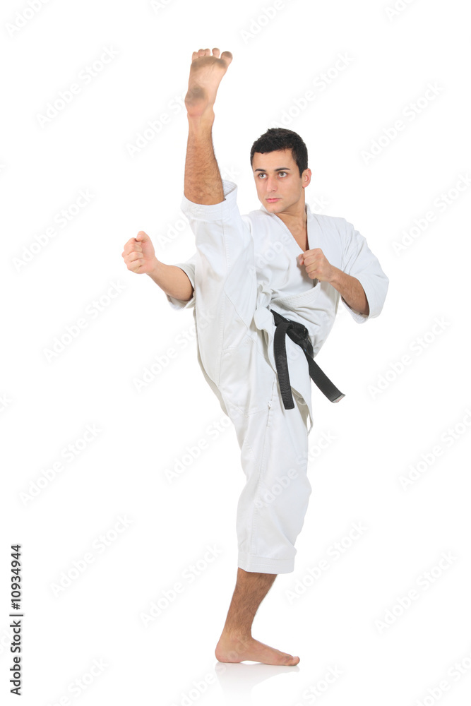 Karate man exercising against white background