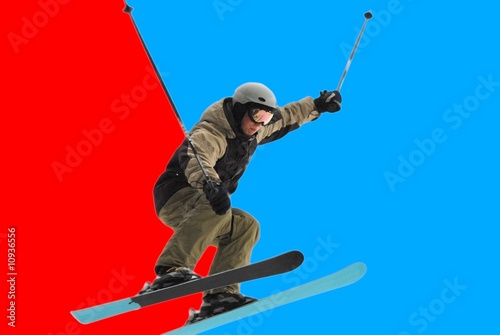 Male skiing over mountain ridge