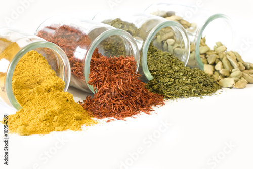 Coloful spices in jars on white background photo