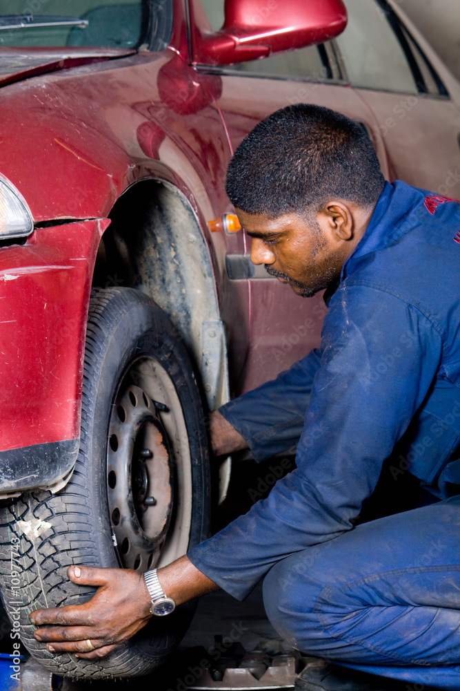 indian mechanic worker changing tyre indian mechanic worker changing tyre