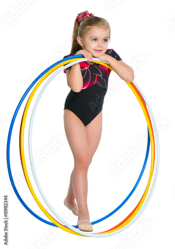 Little girl  holding sevral gymnastic rings photo