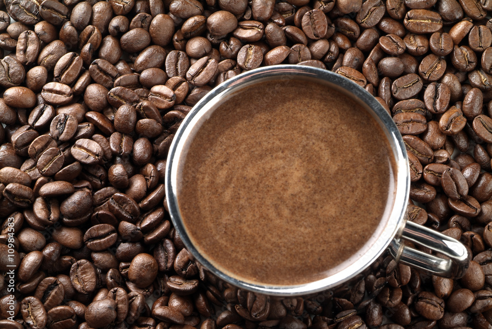 Fototapeta premium Cup with coffee, costing on coffee grain.