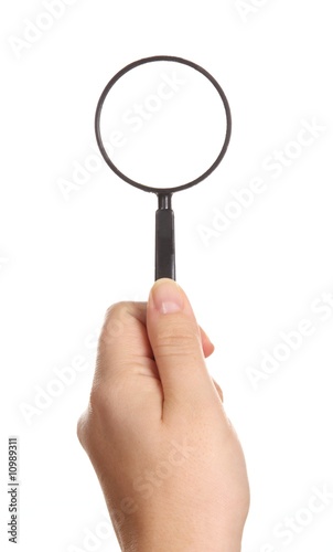 Magnifying glass in woman hand isolated on white background
