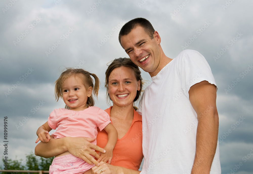 Happy parents with the daughter outside