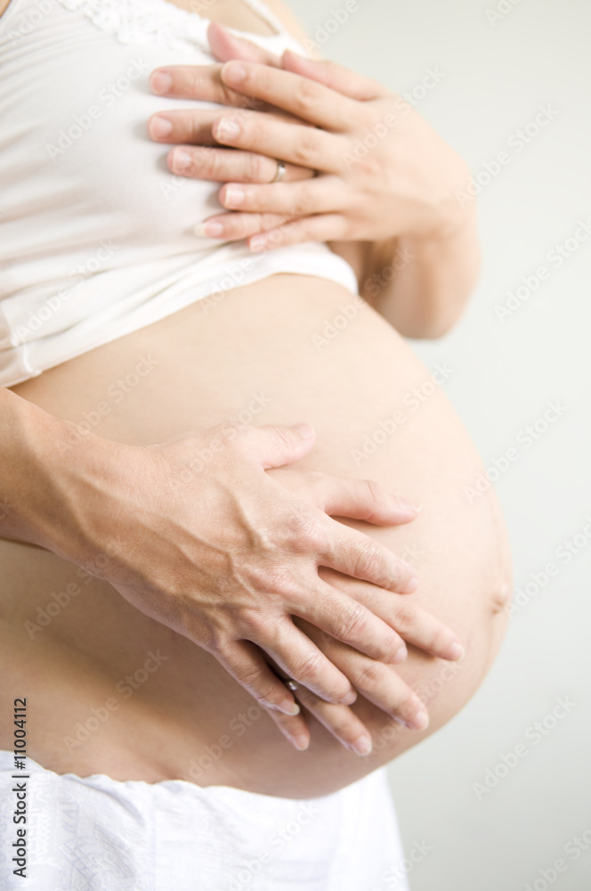 Baby on Board. Mom and Dad with hands on the baby.