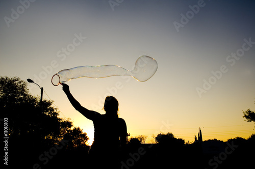 Woman making bubbles photo