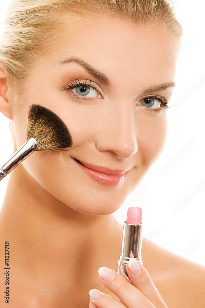 Beautiful young woman with a make-up brush. Beautiful young woman with a make-up brush.