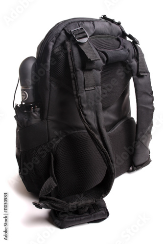 Used black backpack isolated with clipping path. Rear view