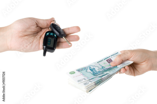 Hand with money and car keys